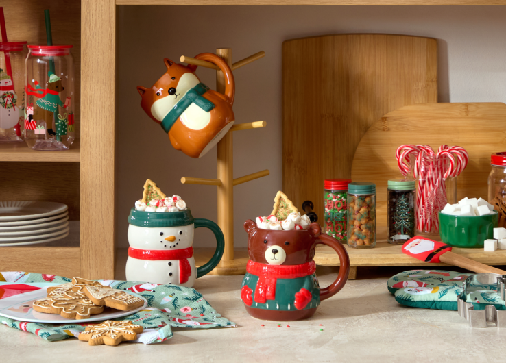 Holiday kitchen décor with festive mugs, treat jars, cookie cutters and Christmas accessories