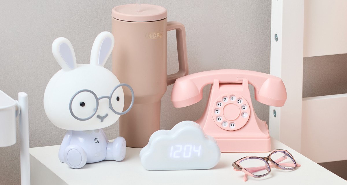 Back-to-school electronics: vintage pink telephone headset, bunny lamp, and whilte cloud-shaped digital clock.