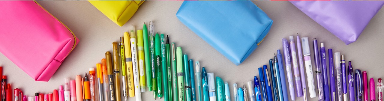 Pens, markers, and highlighters in a rainbow of colors with sticky notes and pencil pouches.