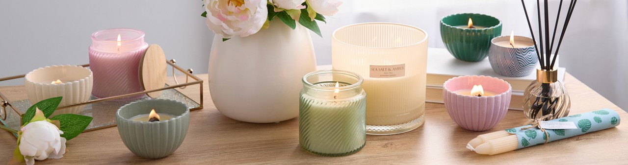 Spring candles and fragrances from pOpshelf: scented container candles, tin candles, candlesticks, and reed diffusers.