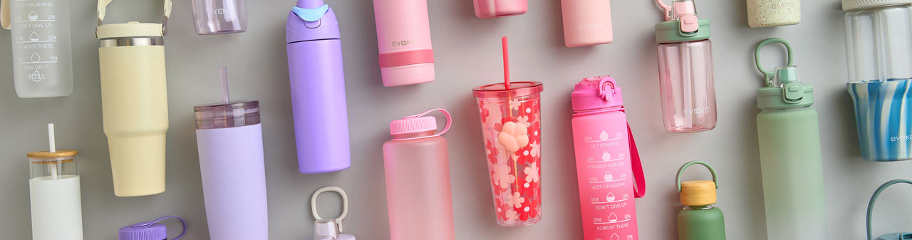 Colorful water bottles: stainless-steel insulated bottles, plastic travel cups, and glass bottles in solids and prints.