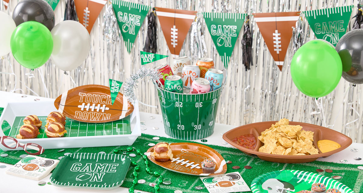 Big Game tablescape with streamers, flag banners, football plates and napkins etc. 