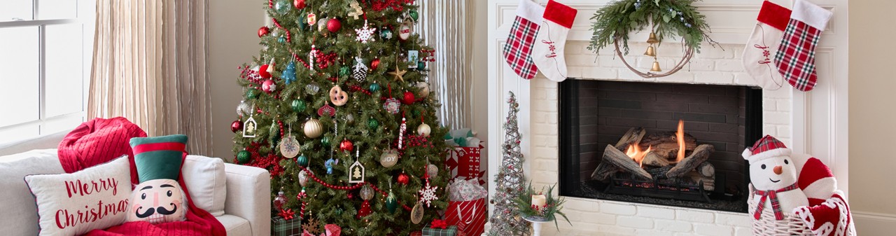 Living room and Christmas Tree decorated for Christmas with stockings, festive Christmas pillows and throws, tabletop decor, trees, candles, sign, wreath & more.