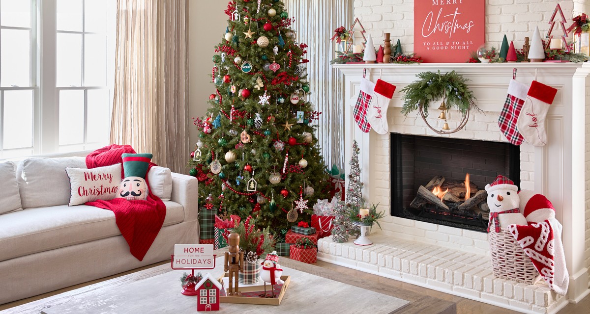 Living room and Christmas Tree decorated for Christmas with stockings, festive Christmas pillows and throws, tabletop decor, trees, candles, sign, wreath & more.