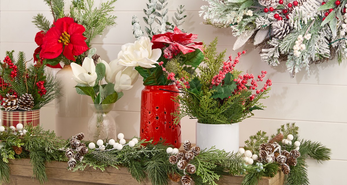 Four vases filled with faux Christmas florals and greenery: red & white poinsettias, frosted & flocked pine and pinecones, Christmas wreath, holly and berries, and more.