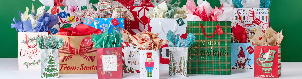 Christmas gift bags with tissue paper in a variety of bag sizes and festive holiday designs from pOpshelf.