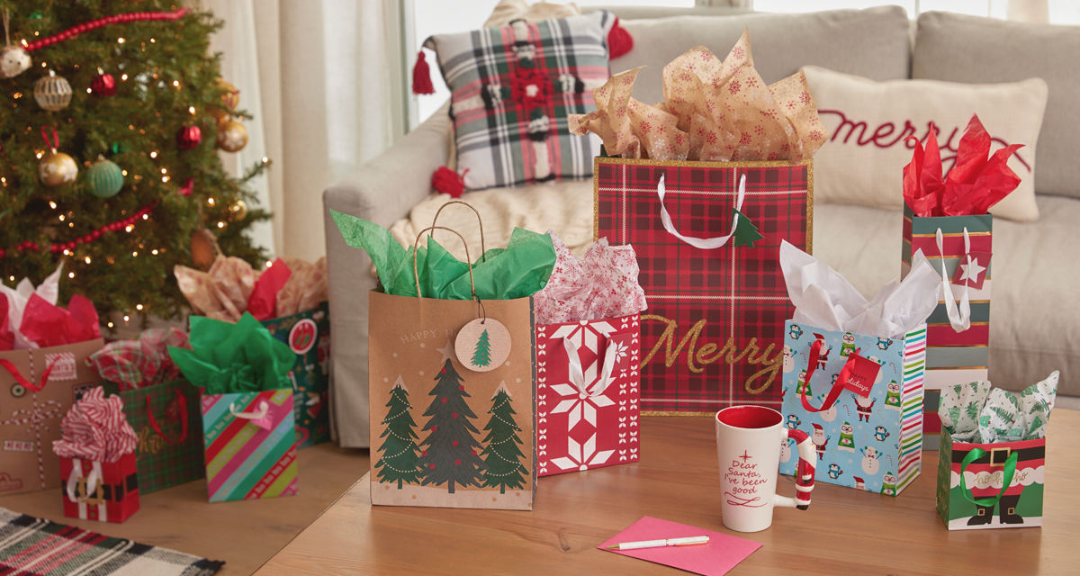 Christmas gift bags with tissue paper in a variety of bag sizes and festive holiday designs from pOpshelf.