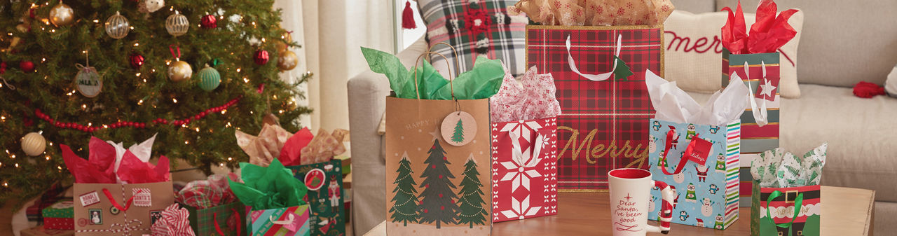 Christmas gift bags with tissue paper in a variety of bag sizes and festive holiday designs from pOpshelf.