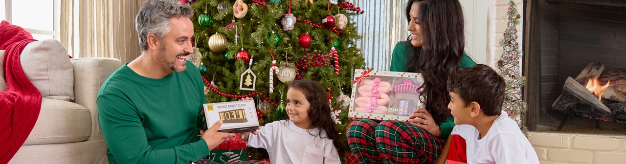 Family opening gifts from pOpshelf together on Christmas morning.