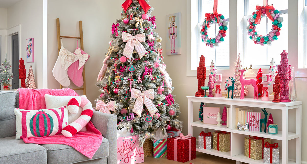 Room decorated with the Merry Merry pink, bows, and sparkly decor collection from pOpshelf: tree ornments, wall art, pillows, throws, tinsel nutcrackers, bottlebrush trees, candles, ornament wreaths & garland.