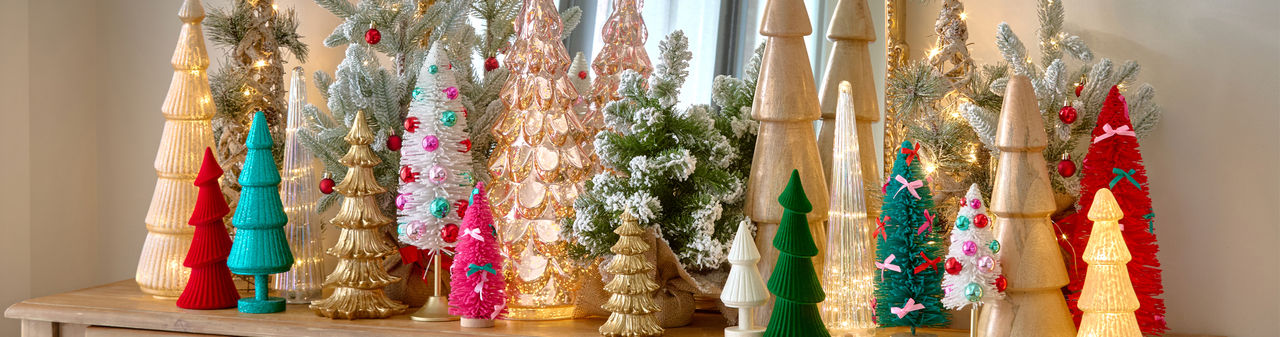 Christmas tree tabletop decor in an array of styles, colors, and materials such as wood, glass, bottlebrush, and more., and more.