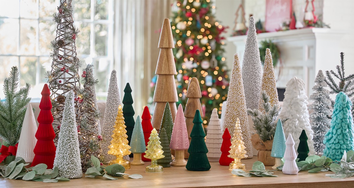 Christmas tree tabletop decor in an array of styles, colors, and materials such as wood, ceramic, felt, and more.