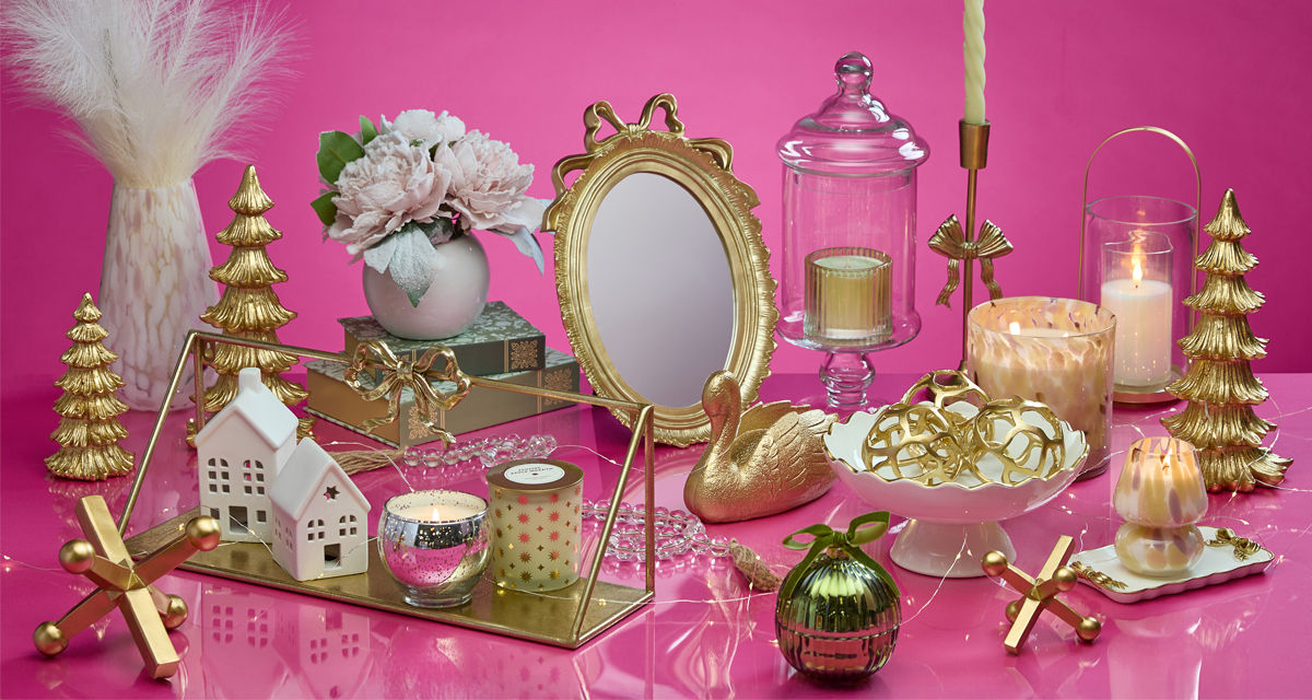 Gift ideas for the decorator from pOpshelf: gold bow candleholders, candles, glass and gold lantern, gold bow mirror, tabletop decor & more.