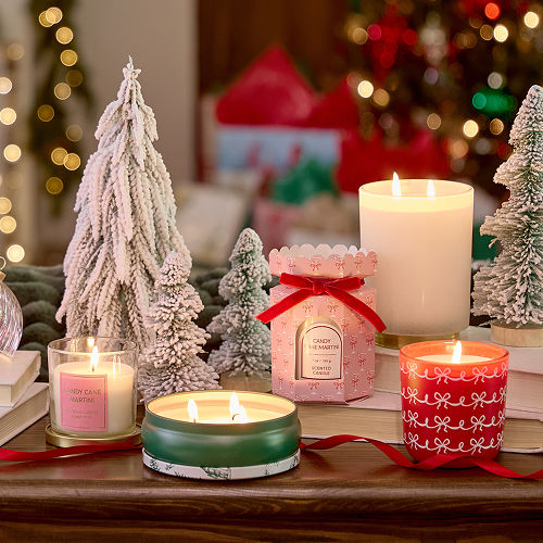 A coffee table decorated with affordable Christmas candles from pOpshelf in classic scents of the holidays with novelty candle jars for Christmastime. 