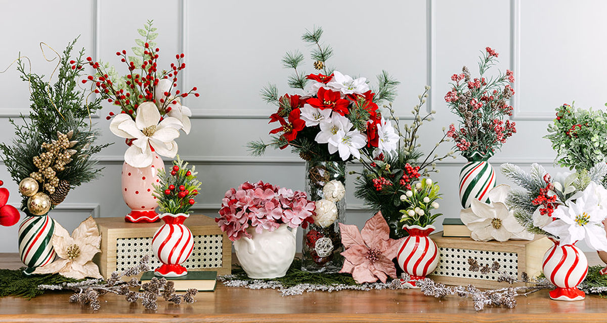 Vases filled with faux Christmas florals and greenery: red, pink & white poinsettias, frosted & flocked pine and pinecones, holly and berries, and more.
