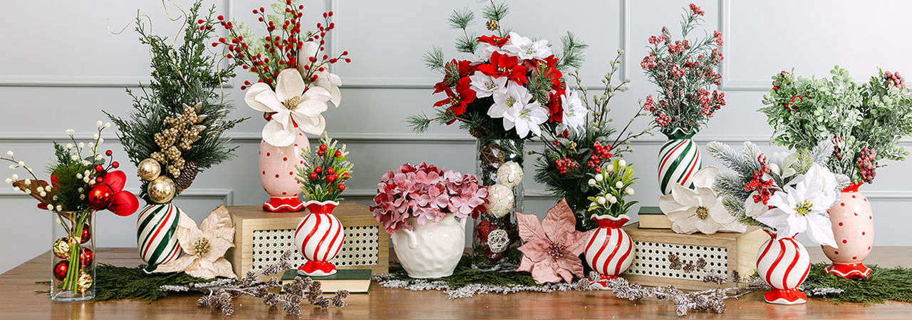 Vases filled with faux Christmas florals and greenery: red, pink & white poinsettias, frosted & flocked pine and pinecones, holly and berries, and more.
