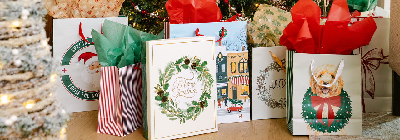 Christmas gift bags with tissue paper in a variety of bag sizes and festive holiday designs from pOpshelf.