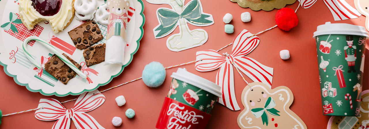 Christmas party table with festive party supplies.