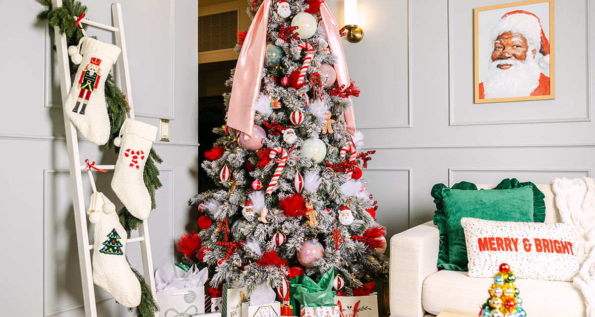 Room decorated with the Up to Snow Good collection: pink bows and sparkly decor on the tree, wall art, pillows, throws, candles, ornament tree & more.