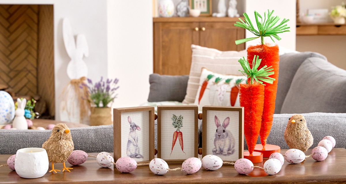Living room decorated with Easter decor from pOpshelf: bottlebrush carrots, rattan bunnies and carrots, egg garland, bunny & carrot decor, and more.