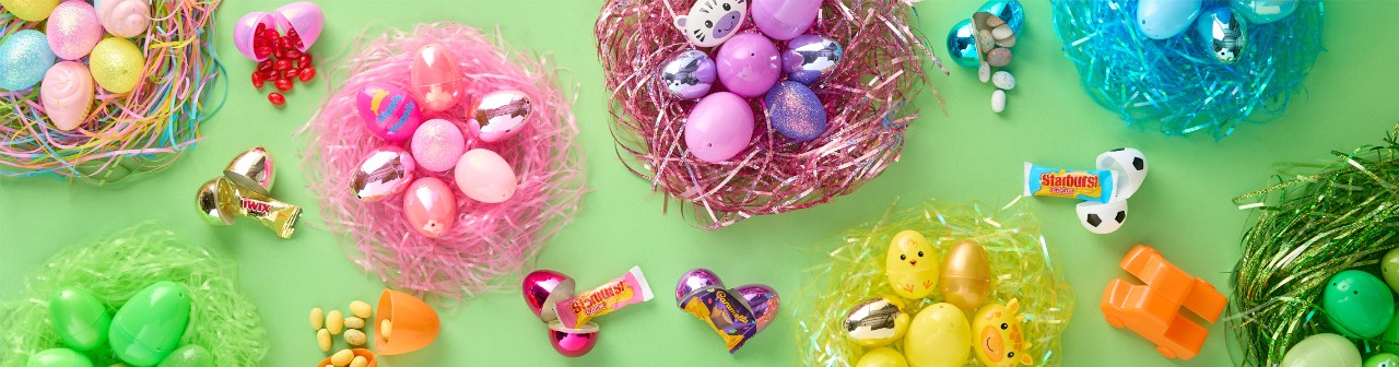 Fillable plastic Easter eggs in multiple bright colors and design and Easter basket grass in assorted rainbow colors from pOpshelf.