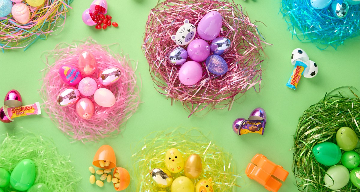 Fillable plastic Easter eggs in multiple bright colors and design and Easter basket grass in assorted rainbow colors from pOpshelf.