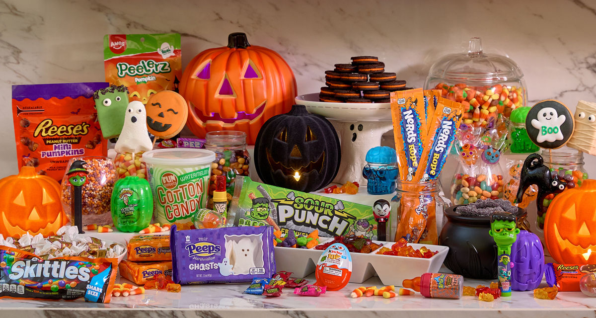 Various colorful Halloween candy and treats: marshmallow Peeps, gummy candy, decorated cookie and rice krispy treat pops, Reese's Pumpkins, candy corn & more.