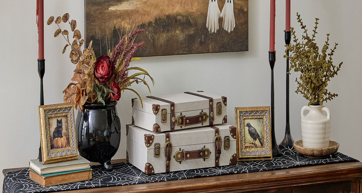 Entryway decorated for Halloween with candles, wall art & more from pOpshelf.