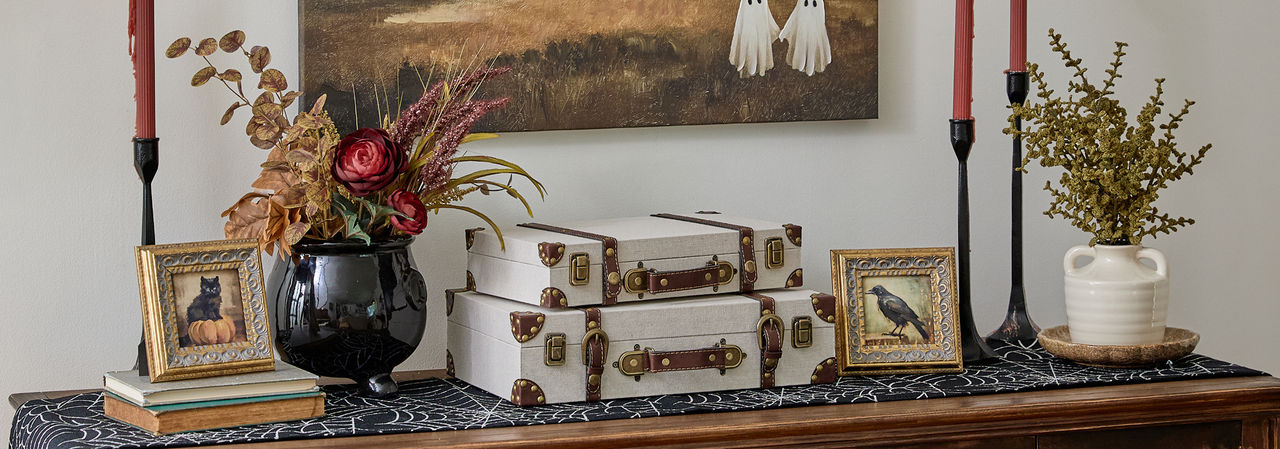 Entryway decorated for Halloween with candles, wall art & more from pOpshelf.