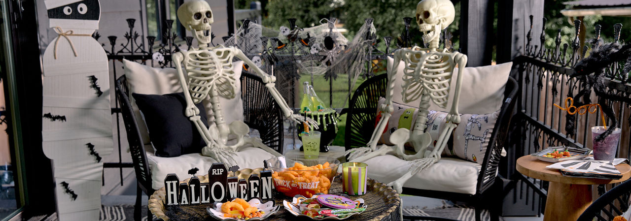 Halloween porch party with skeletons and party supplies from pOpshelf.