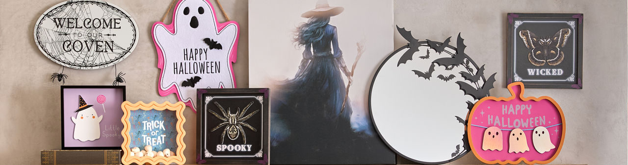 Various colorful Halloween signs: round bat mirror, Hocus Pocus sign, checkered Groovy Goblin sign, Spooky sign, BOO Ghost sign, and more.