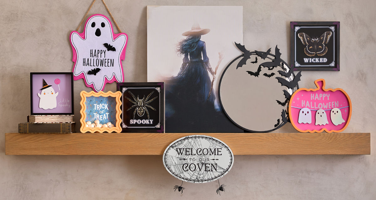 Various colorful Halloween signs: round bat mirror, Hocus Pocus sign, checkered Groovy Goblin sign, Spooky sign, BOO Ghost sign, and more.