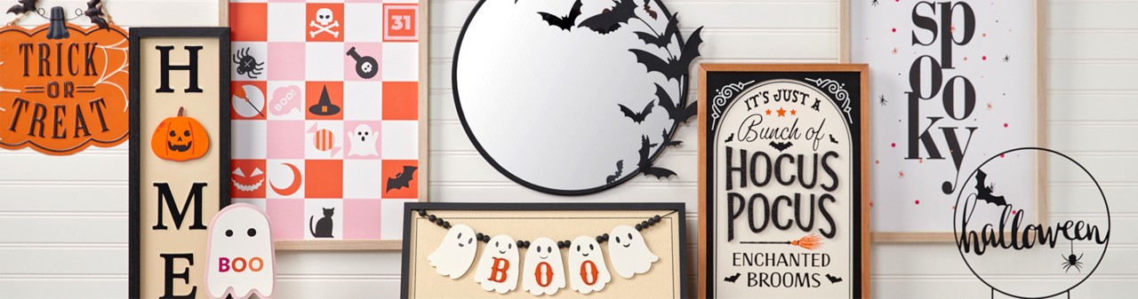 Various colorful Halloween signs: round bat mirror, Hocus Pocus sign, checkered Groovy Goblin sign, Spooky sign, BOO Ghost sign, and more.
