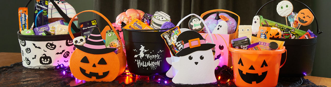 Halloween trick-or-treat buckets and pails filled with candy and goodies from pOpshelf. 