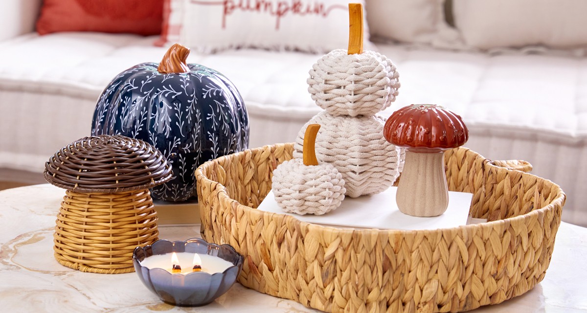 Fall tabletop decor: blue ceramic pumpkin, wicker mushrooms, blue glass candle, wicker pumpkins & more.