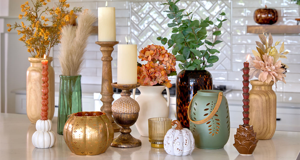 Fall vases and candleholders in various designs and colors in a kitchen.