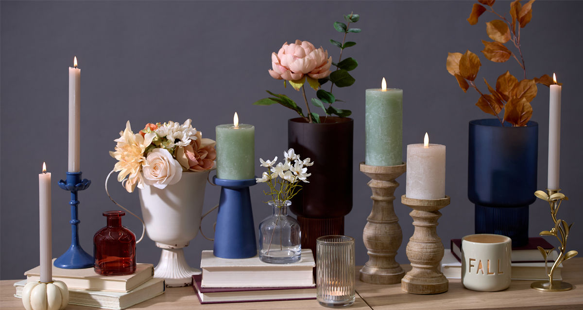 Fall vases and candleholders in various designs and colors in a kitchen.