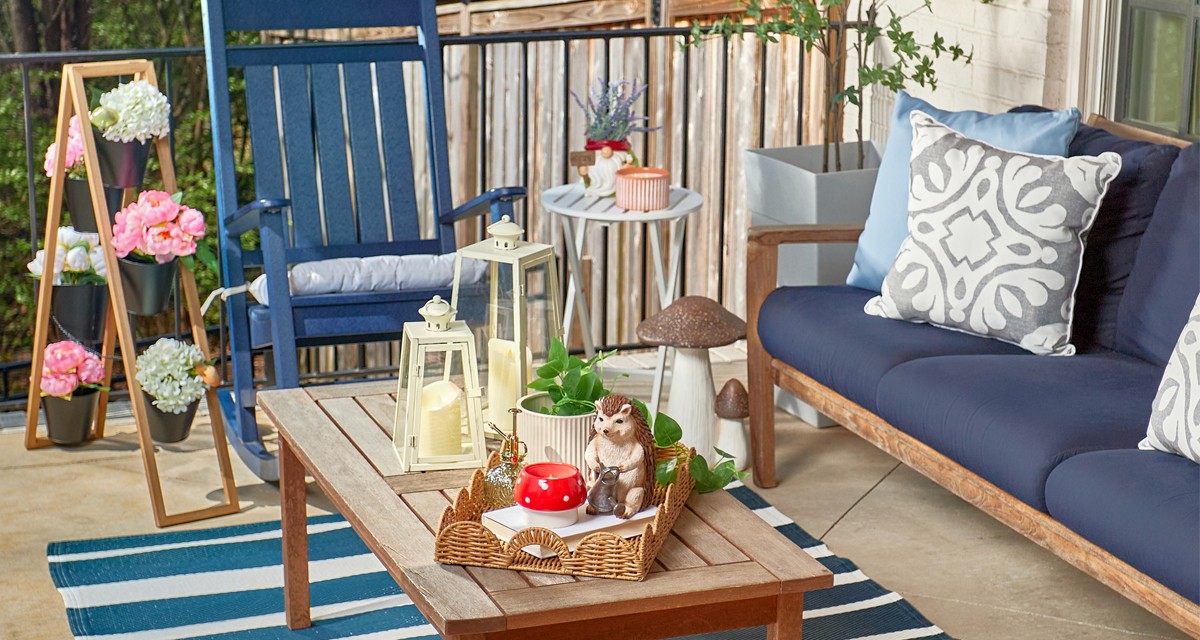 Patio decorated with new lawn & garden decor, pillows, chair cushions, and planters from pOpshelf.