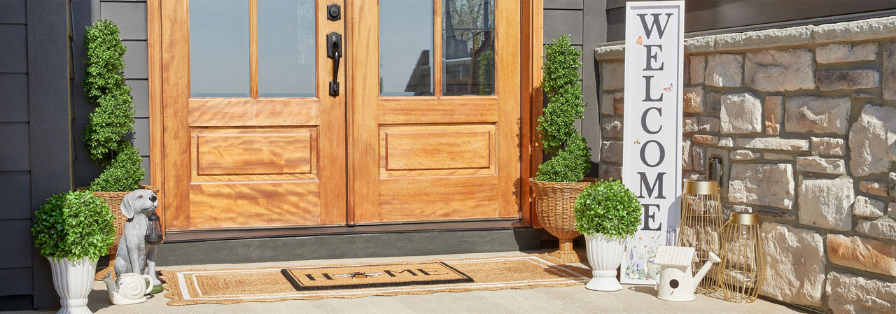 Front porch decorated with garden & patio décor from pOpshelf: wreath, lanterns, porch leaner, potted plants and topiaries, garden decor & more.