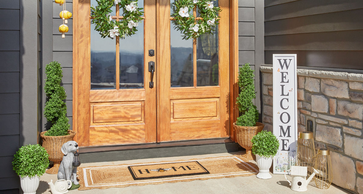 Front porch decorated with garden & patio décor from pOpshelf: wreath, lanterns, porch leaner, potted plants and topiaries, garden decor & more.