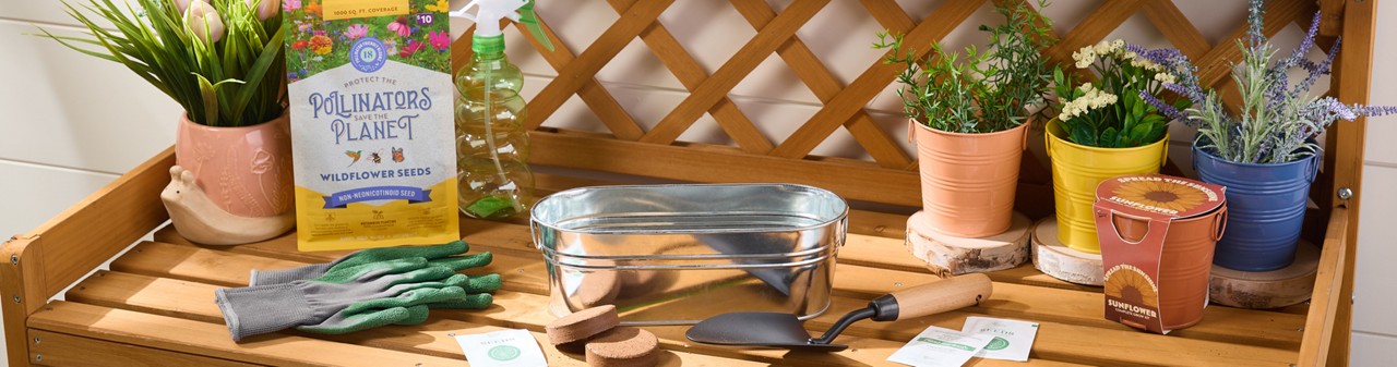 Potting bench with gardening tools, watering can, garden pots, and gardening seeds, bulbs, and grow kits from pOpshelf.