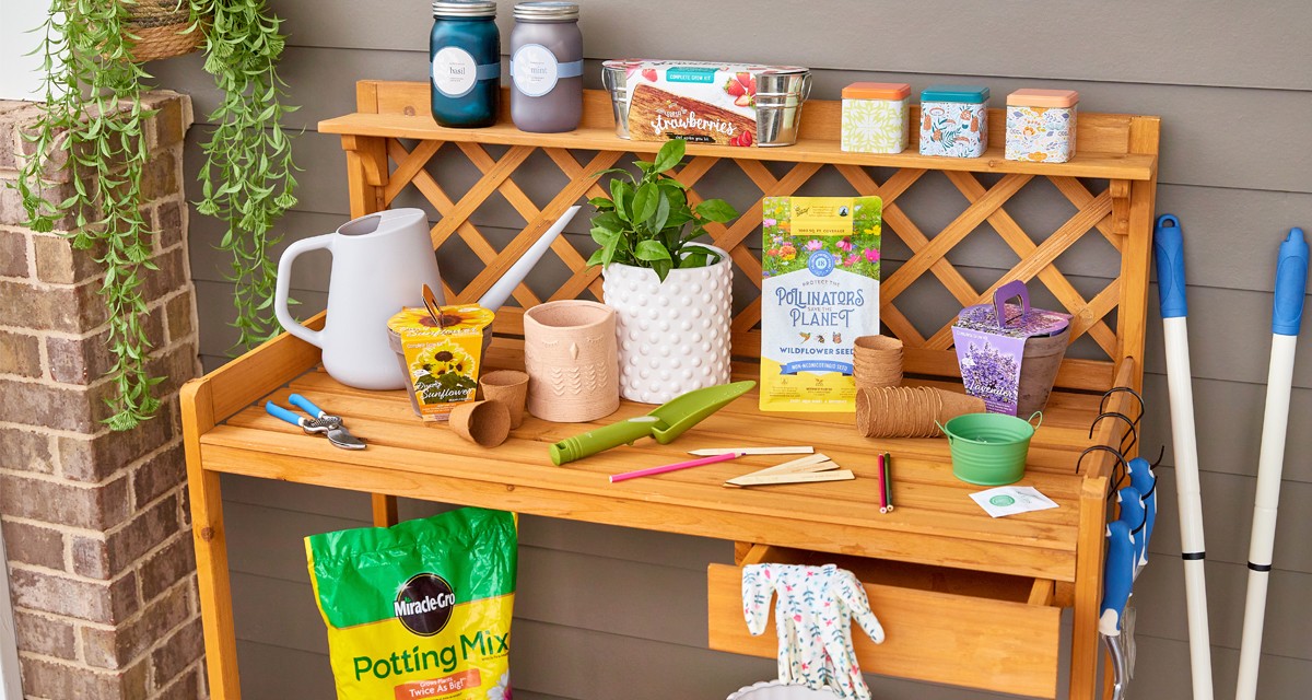 Potting bench with gardening tools, potting soil, watering can, garden pots, and gardening seeds, bulbs, and grow kits from pOpshelf.