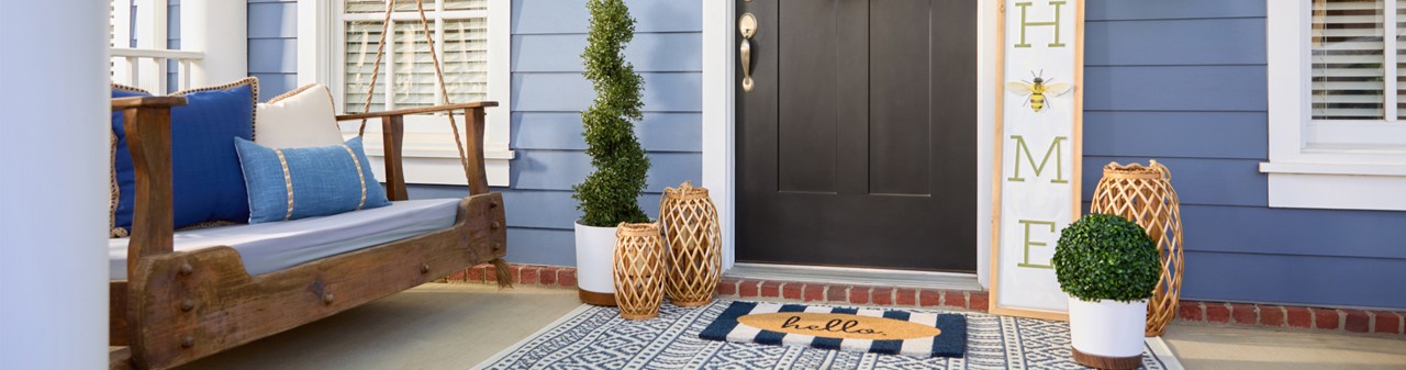 Front porch decorated with garden & patio décor from pOpshelf: wreath, lanterns, porch leaner, potted plants and topiaries, garden decor & more.