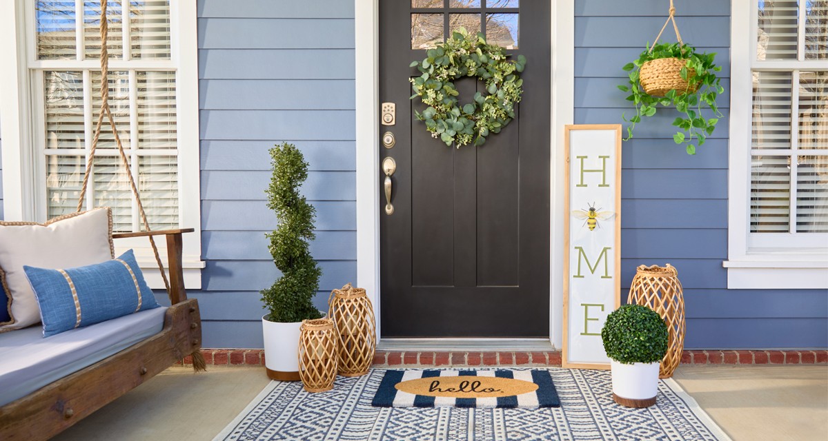 Front porch decorated with garden & patio décor from pOpshelf: wreath, lanterns, porch leaner, potted plants and topiaries, garden decor & more.