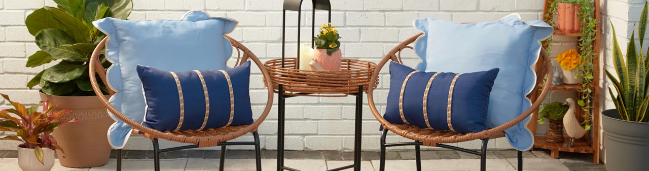 Backyard with outdoor patio chair and table, outdoor rugs & pillows, and garden & patio decor and solar lanterns from pOpshelf.