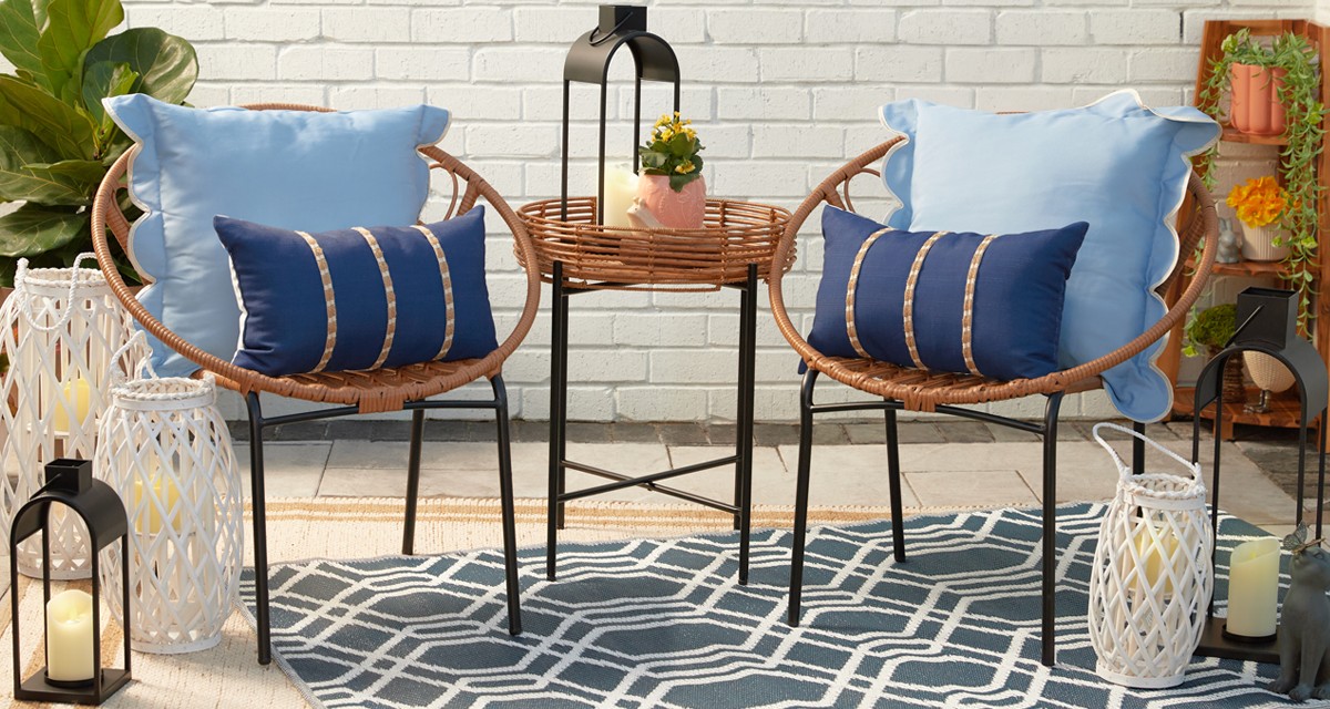 Backyard with outdoor patio chair and table, outdoor rugs & pillows, and garden & patio decor and solar lanterns from pOpshelf.