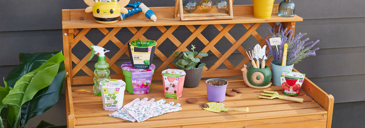 Potting bench with gardening tools, watering can, garden pots, and gardening seeds, bulbs, and grow kits from pOpshelf.