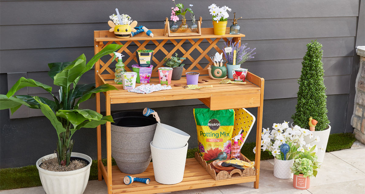 Potting bench with gardening tools, watering can, garden pots, and gardening seeds, bulbs, and grow kits from pOpshelf.