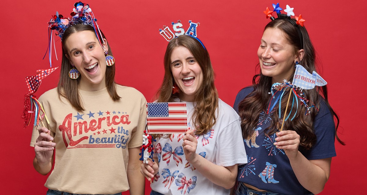Women wearing red, white & blue patrioc apparel & accessories from pOpshelf: USA trucker hats, patriotic earrings and necklaces, patriotic headbands, patriotic t-shirts, and more.