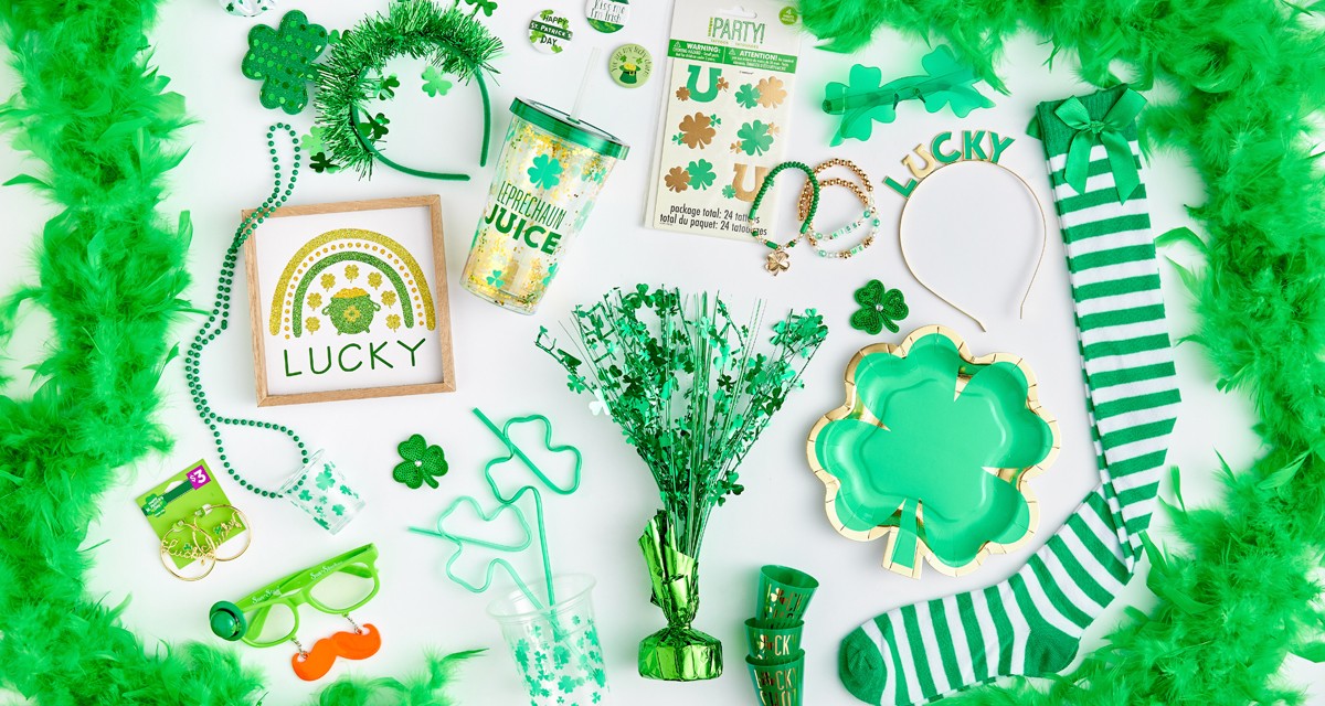 St. Patrick's Day party items: green feather boa, shot glasses, necklaces, wall art, paper plates, stickers, socks & more.